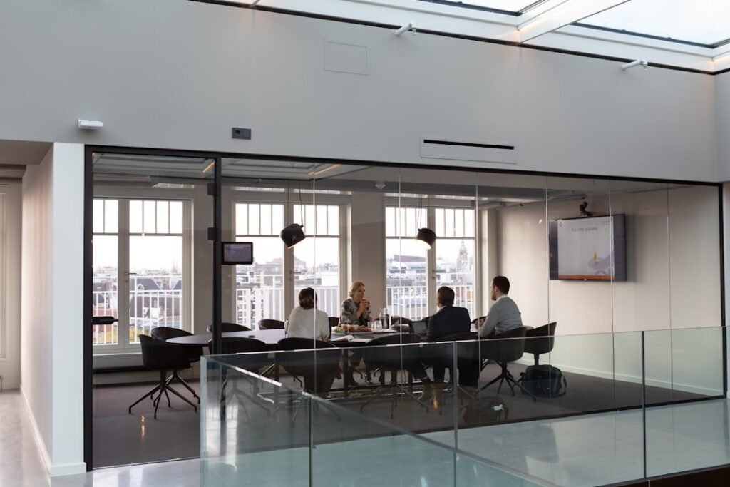 Colleagues in a boardroom discussion around a meeting table