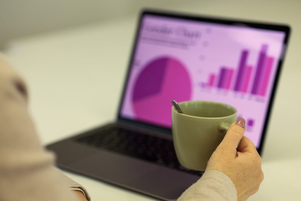 Person reviewing charts and analytics on a laptop screen